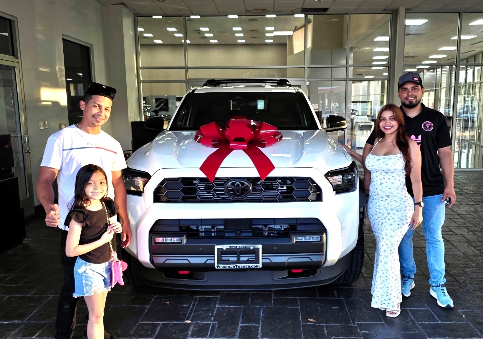 Family celebrating their new Toyota 4Runner at Freeman Toyota in Hurst TX
